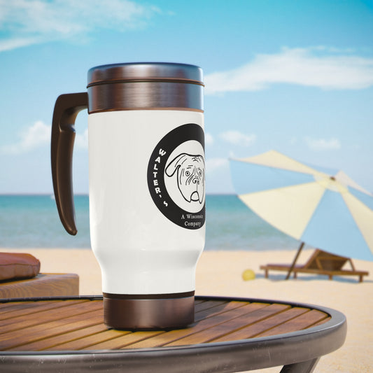 White Walter travel mug with black handle and lid on a table beside the beach.